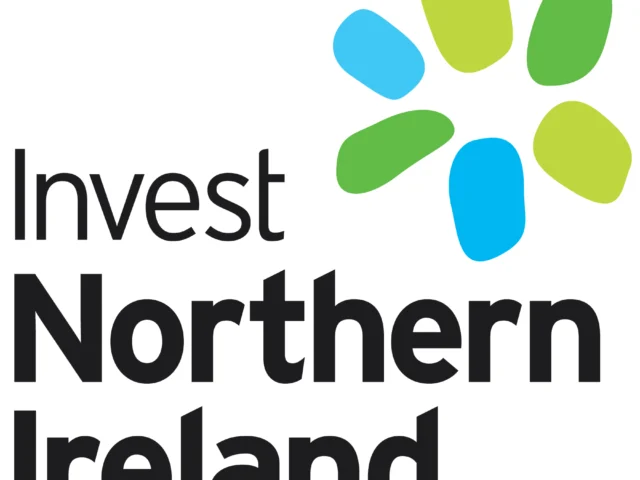 The Invest Northern Ireland logo with black text and six abstract blue and green shapes arranged in a circular pattern above.