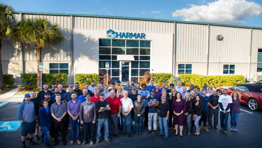 Harmar team standing in front of Harmar's warehouse