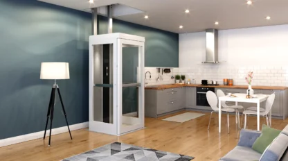 Modern kitchen and living area with wooden floors, featuring a home elevator, a tripod floor lamp, and contemporary furniture.
