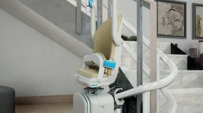 A motorized stair lift with a beige seat is installed along a curved staircase in a modern home interior.
