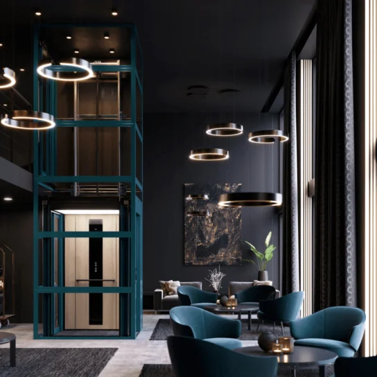 Modern lounge with teal velvet chairs, circular pendant lights, and a glass-walled elevator at the center, featuring dark walls and tall windows letting in natural light.