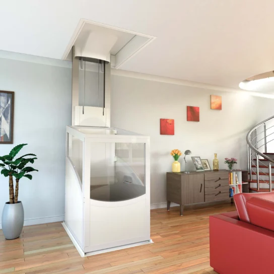 A modern residential living room with a compact home elevator installed next to a sideboard, houseplant, and red sofa; spiral staircase is visible in the background.