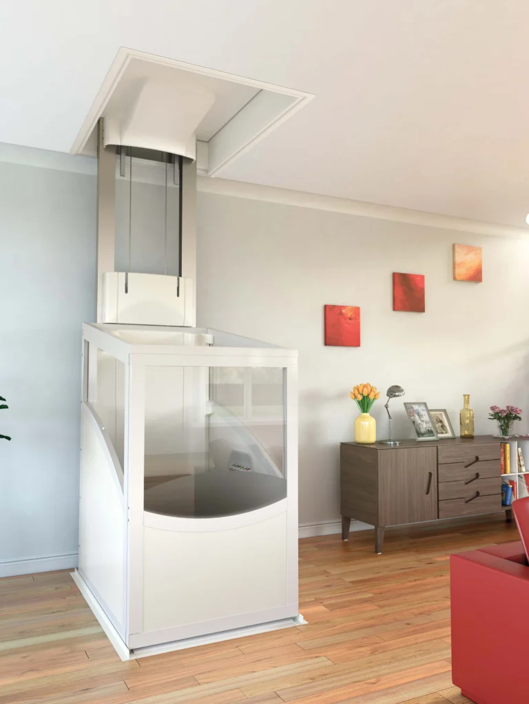 A modern residential living room with a compact home elevator installed next to a sideboard, houseplant, and red sofa; spiral staircase is visible in the background.
