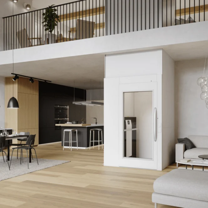 Modern open-plan living area with a small residential elevator, dining table, kitchen, and staircase leading to an upper loft. Minimalist decor and neutral color palette.