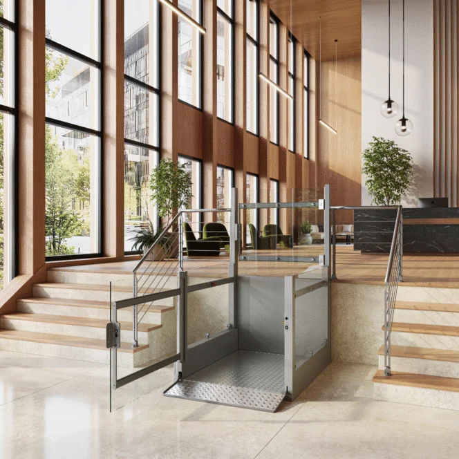 A modern indoor space with large windows features a platform lift between two staircases, providing accessible entry to an elevated area.