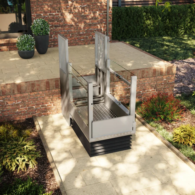 A vertical platform lift is installed next to a brick porch, providing accessible entry from the lower patio to the raised entrance.