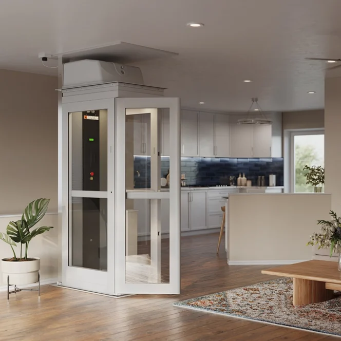 A modern residential living room and kitchen with a compact home elevator installed near a sofa, a wooden coffee table, and a potted plant.
